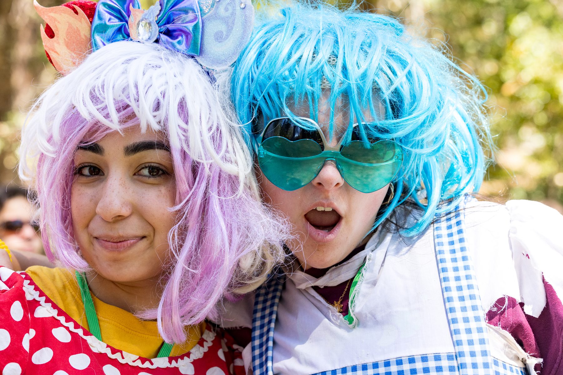 Two Camp Kesem counsellors in pink and blue costume wigs
