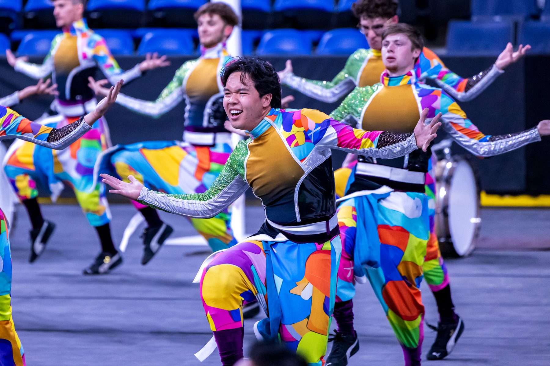 A winter percussion ensemble in colour-block costume mid-routine